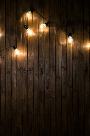 Light bulbs on dark Wooden Background real imageの写真素材