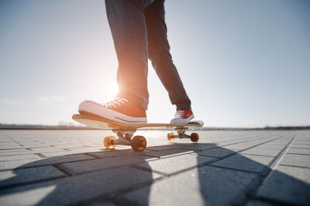 skater riding a skateboard. view of a person riding on his skate wearing casual clothes
