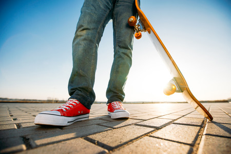 skater riding a skateboard. view of a person riding on his skate wearing casual clothesの写真素材