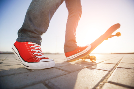 skater riding a skateboard. view of a person riding on his skate wearing casual clothesの写真素材