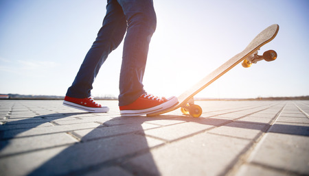 skater riding a skateboard. view of a person riding on his skate wearing casual clothesの写真素材
