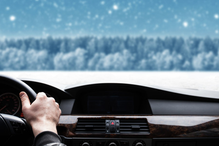 car window view on Blue Christmas background with trees and snowの写真素材