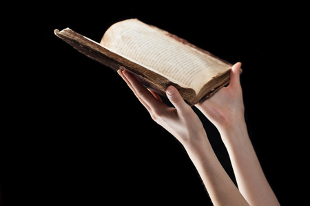woman reading the bible in the darknessの写真素材