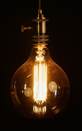 vintage light bulb over darkの写真素材