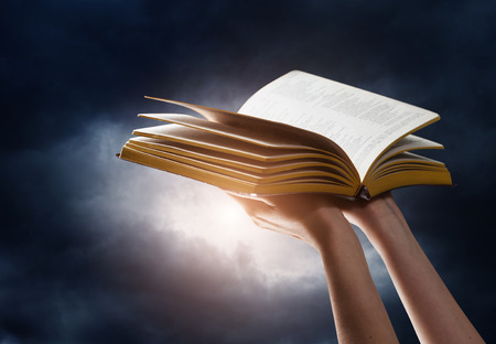 woman reading the bible in the darknessの写真素材