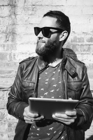 hipster man using tablet pc outsideの写真素材