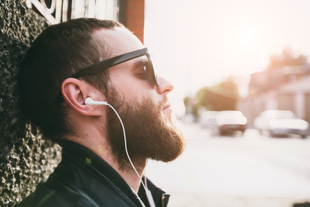 Hipster listening to music portraitの写真素材