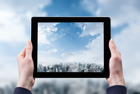 woman hand taking photo of the city with a tablet pcの写真素材