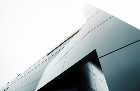Wide angle abstract background view of steel light blue high rise commercial building skyscraper made of glass exterior. concept of successful industrial architecture and office center buildingの写真素材