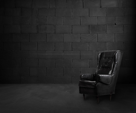 Black brick room interior design with armchairの写真素材