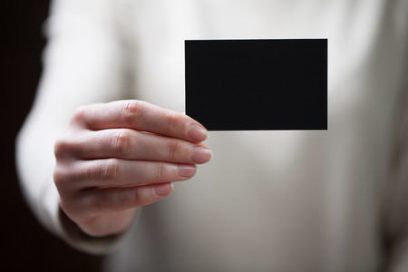 Hand holding blank business cardの写真素材