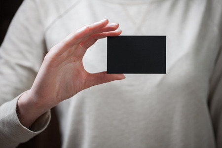 Hand holding blank business cardの写真素材