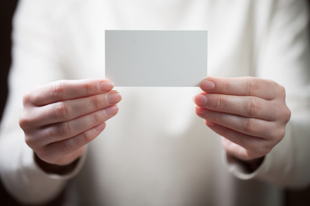 Hand holding blank business cardの写真素材