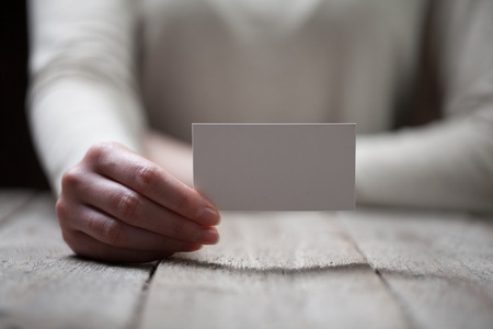 Hand holding blank business cardの写真素材