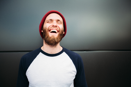 Hipster man smiling and wearing white blank t-shirtの写真素材