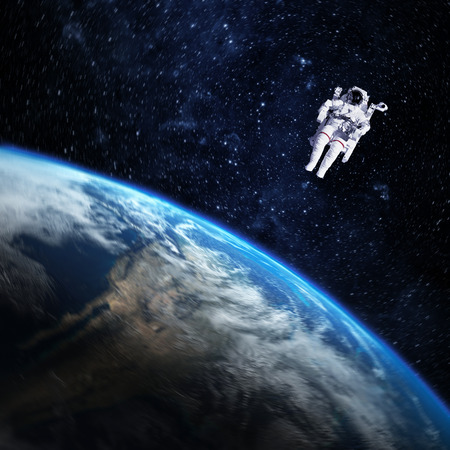 Astronaut in outer space against the planet earth.の写真素材