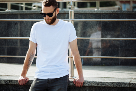Hipster wearing white blank t-shirt with space for your logoの写真素材