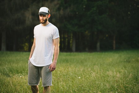 Hipster man wearing white blank t-shirt with space for your logoの写真素材