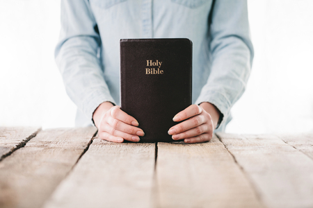 Woman reading and praying over Bible
