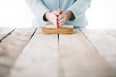 Woman reading and praying over Bibleの写真素材