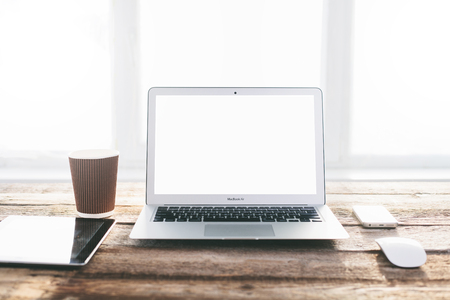 Laptop with isolated screen on a tableの写真素材