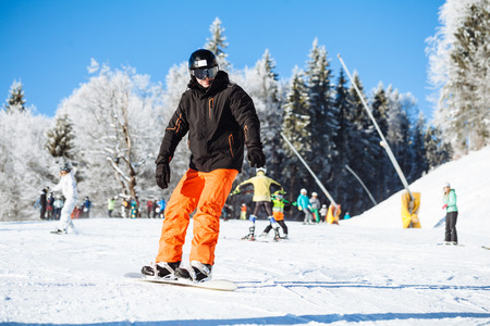 Snowboarder skating in the mountains with deep blue skyの写真素材
