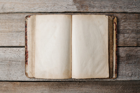 Opened retro empty book on wooden floorの写真素材