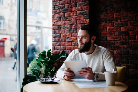 Man working using tablet pc at a coffeeshopの写真素材