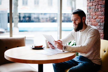 Man working using tablet pc at a coffeeshopの写真素材
