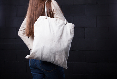 Woman holding an empty bag for logoの写真素材