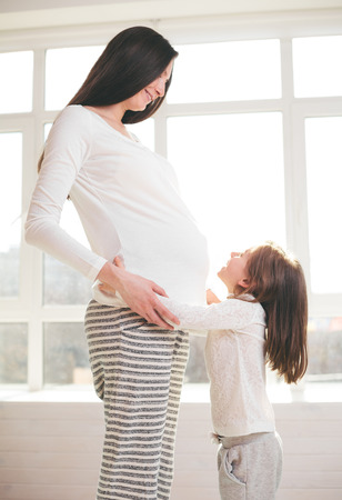 Pregnant woman and a child huggingの写真素材