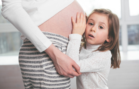 Pregnant woman and a child huggingの写真素材