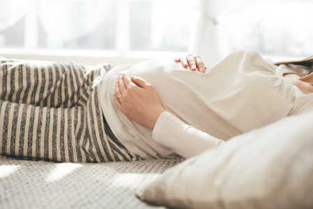 Pregnant woman in bedの写真素材