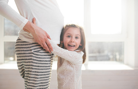 Pregnant woman and a child huggingの写真素材