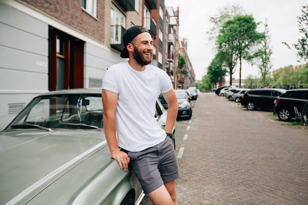 Hipster  model with beard  wearing white blank  t-shirt with space for your logo or design in casual urban styleの写真素材