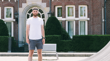 Hipster handsome male model with beard  wearing white blank  t-shirt with space for your logo or design in casual urban styleの写真素材