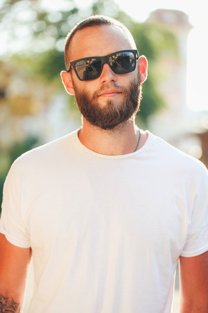 Hipster man wearing black sunglasses in urban city streetsの写真素材