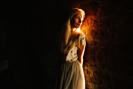 Blonde girl in a darkの写真素材