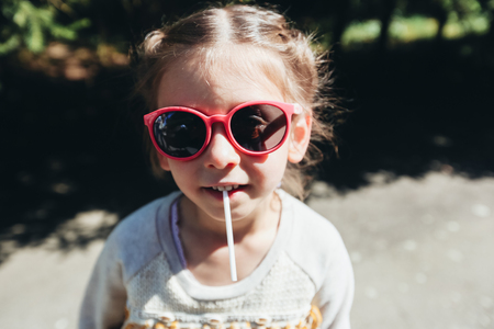 Girl kid smiling wearing sunglassesの写真素材
