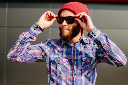 Sexy hipster man with beard posing wearing trendy clothesの写真素材
