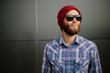 Sexy hipster man with beard posing wearing trendy clothesの写真素材