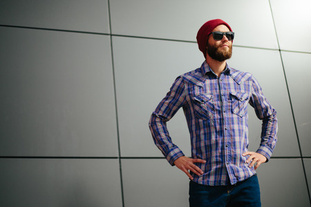Sexy hipster man with beard posing wearing trendy clothes