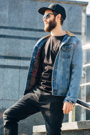 Hipster handsome male model with beard  wearing black blank  t-shirt with space for your logo or design in casual urban styleの写真素材