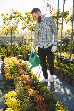 Hipster gardener working in the garden in the cityの写真素材
