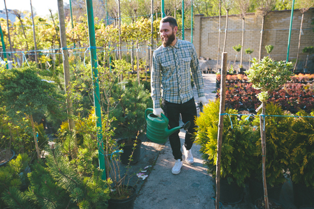Hipster gardener working in the garden in the cityの写真素材