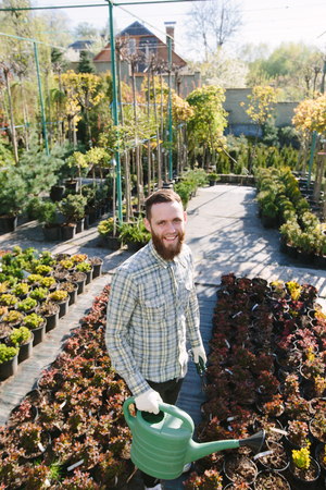Hipster gardener working in the garden in the cityの写真素材