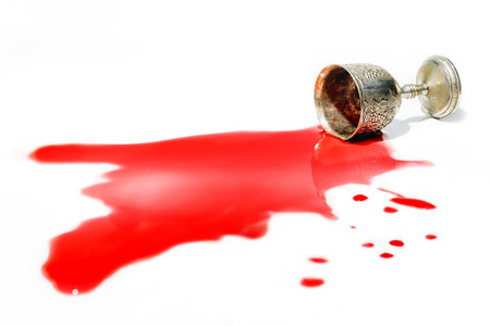 Poison being poured from an old silver vine cupの写真素材