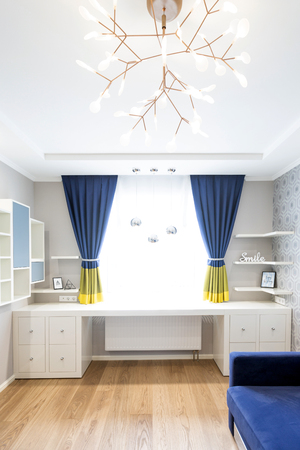 Modern living room interior design with blue sofa and a big windowの写真素材