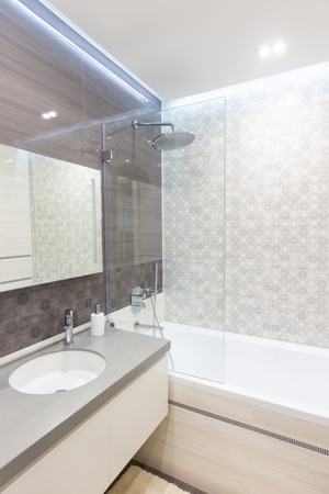 Modern bathroom with shower and a sinkの写真素材