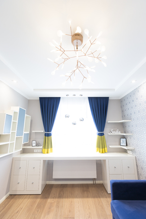 Modern living room interior design with blue sofa and a big windowの写真素材